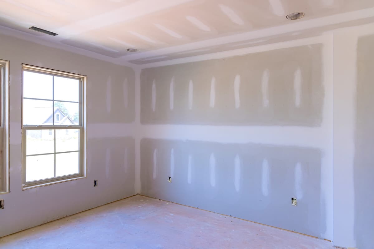 Renovated hallway and staircase mid-project, drywall complete